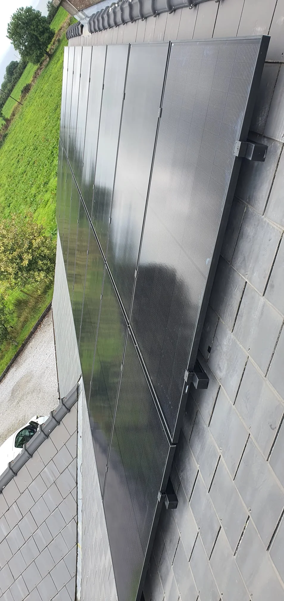 Black solar PV panels installed on a slate roof